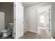 Room with neutral walls, carpet flooring, and access to a bathroom featuring a modern toilet at 1211 W 30Th St, Indianapolis, IN 46208