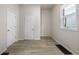 Room with neutral walls, updated flooring, and a window providing natural light, next to two doors at 1211 W 30Th St, Indianapolis, IN 46208