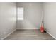 Simple room featuring neutral walls, updated flooring, and a window providing natural light at 1211 W 30Th St, Indianapolis, IN 46208
