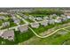 Panoramic aerial view of a well-designed community with homes surrounding a tranquil pond and green spaces at 12127 Whisper Ridge Dr, Noblesville, IN 46060