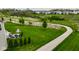 A vast green backyard with a paved walking trail and patio area for entertaining at 12127 Whisper Ridge Dr, Noblesville, IN 46060