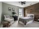 Cozy bedroom featuring a custom wood accent wall, soft lighting, and comfortable furnishings at 12127 Whisper Ridge Dr, Noblesville, IN 46060