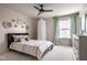 Charming bedroom with pastel accents, featuring a cozy bed and a sunlit window at 12127 Whisper Ridge Dr, Noblesville, IN 46060