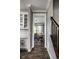 Hallway view of dining area featuring dark wood floors, chandelier lighting, and abundant natural light at 12127 Whisper Ridge Dr, Noblesville, IN 46060