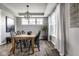 Elegant dining room featuring a wooden table, chandelier lighting, and large windows with curtains at 12127 Whisper Ridge Dr, Noblesville, IN 46060