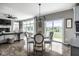 Sunlit dining area with views of the outdoors, adjacent to a comfortable living space at 12127 Whisper Ridge Dr, Noblesville, IN 46060