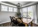 Bright dining room with natural light, wood table, chandelier, and views of outdoor scenery at 12127 Whisper Ridge Dr, Noblesville, IN 46060