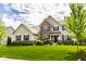 Beautiful two-story home with brick and siding exterior, enhanced by a lush green lawn and landscape at 12127 Whisper Ridge Dr, Noblesville, IN 46060