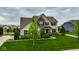 Charming two-story home featuring brick and siding exterior with well-maintained lawn and manicured landscape at 12127 Whisper Ridge Dr, Noblesville, IN 46060