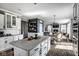 Open-concept kitchen with an island connecting the dining room and living space at 12127 Whisper Ridge Dr, Noblesville, IN 46060