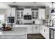 Well-equipped kitchen showcasing stainless steel appliances, white cabinetry, and granite counters at 12127 Whisper Ridge Dr, Noblesville, IN 46060