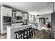 Modern kitchen with island, stainless steel appliances, and open layout to living area at 12127 Whisper Ridge Dr, Noblesville, IN 46060