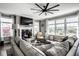 Cozy living room with a large sectional sofa, fireplace, and an abundance of natural light at 12127 Whisper Ridge Dr, Noblesville, IN 46060