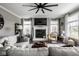Inviting living room with a fireplace, comfortable seating, and bright natural lighting at 12127 Whisper Ridge Dr, Noblesville, IN 46060