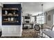 Bright living room featuring stylish decor, a cozy fireplace, and dark-stained floating shelves at 12127 Whisper Ridge Dr, Noblesville, IN 46060