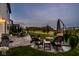 Relaxing outdoor patio with fire pit, comfortable seating, and serene views of the surrounding landscape at 12127 Whisper Ridge Dr, Noblesville, IN 46060