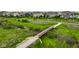 A walking trail and bridge wind through a beautiful green space near the homes at 12127 Whisper Ridge Dr, Noblesville, IN 46060