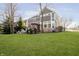 The home's backyard features a stone fire pit, seating, hot tub and pergola, perfect for relaxation at 12433 Harvest Glen Blvd, Fishers, IN 46037