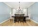 Dining room with a large wooden table, upholstered chairs, a chandelier, and light blue walls at 12433 Harvest Glen Blvd, Fishers, IN 46037