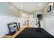 Bright exercise room with workout equipment, chair rail molding, and double French doors at 12433 Harvest Glen Blvd, Fishers, IN 46037