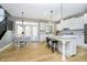 Bright kitchen with white cabinets, an island with seating, stainless steel appliances and hardwood floors at 12433 Harvest Glen Blvd, Fishers, IN 46037