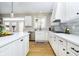 Well-lit kitchen with white cabinetry, stainless steel appliances, and quartz countertops, exuding elegance at 12433 Harvest Glen Blvd, Fishers, IN 46037