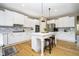 Spacious kitchen featuring white cabinets, a kitchen island with seating, and stainless steel appliances at 12433 Harvest Glen Blvd, Fishers, IN 46037