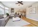 Open living space with light wood floors, a neutral rug, and views into the kitchen at 12433 Harvest Glen Blvd, Fishers, IN 46037