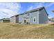 Beautiful new home's backyard with outdoor seating and a fun backyard swing set at 1399 Hat Band St, Danville, IN 46122