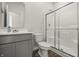 Modern bathroom with a gray vanity, toilet, and glass-enclosed shower, complemented by wood-look flooring at 1399 Hat Band St, Danville, IN 46122