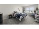 Cozy bedroom with a bed, a nightstand, a small desk, and lots of light at 1399 Hat Band St, Danville, IN 46122