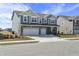 Attractive two-story house featuring a two-car garage, brick details, gray siding, and manicured lawn at 1399 Hat Band St, Danville, IN 46122
