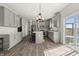 Bright kitchen with gray cabinets, stainless steel appliances, a center island, and access to the backyard at 1399 Hat Band St, Danville, IN 46122