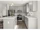 Bright kitchen features a center island, stainless steel appliances and grey cabinetry at 1399 Hat Band St, Danville, IN 46122