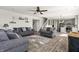Spacious living room offering wood floors, modern furnishings, an open staircase, and a partial view of the kitchen at 1399 Hat Band St, Danville, IN 46122