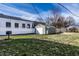 Backyard features a detached garage, grass, a privacy fence and a black grill at 14 N Edmondson Ave, Indianapolis, IN 46219