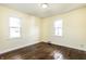 Inviting bedroom with hardwood floors and ample natural light from two windows at 14 N Edmondson Ave, Indianapolis, IN 46219