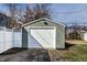 Detached garage with new siding features a white garage door and an asphalt driveway at 14 N Edmondson Ave, Indianapolis, IN 46219
