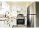 Bright kitchen features modern appliances, wood countertops, and white cabinetry at 14 N Edmondson Ave, Indianapolis, IN 46219