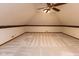 Unfinished attic space featuring carpet and patterned wall paper border at 154 Dover N Blvd, Brownsburg, IN 46112