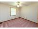 Bright bedroom featuring plush carpet, ceiling fan, and natural light from a window at 154 Dover N Blvd, Brownsburg, IN 46112