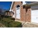 Close-up of the front entrance showing a decorative door and brick facade at 154 Dover N Blvd, Brownsburg, IN 46112