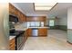 Kitchen featuring stainless steel appliances, wood cabinetry, and tile flooring at 154 Dover N Blvd, Brownsburg, IN 46112