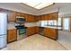 Kitchen featuring stainless steel appliances, wood cabinetry, and tile flooring at 154 Dover N Blvd, Brownsburg, IN 46112