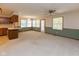 Bright living room features large windows, neutral carpet, and a ceiling fan at 154 Dover N Blvd, Brownsburg, IN 46112