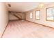 Empty living room space with a staircase and multiple windows providing natural light at 154 Dover N Blvd, Brownsburg, IN 46112