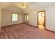 Spacious main bedroom with ceiling fan, closet, and pink carpet at 154 Dover N Blvd, Brownsburg, IN 46112
