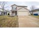 Two-story home featuring a two-car garage, neutral siding, and red shutters in a well-maintained community at 15444 Wandering Way, Noblesville, IN 46060