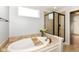 Soaking tub and a glass shower create a spa-like experience in this bathroom at 16753 Workington Way, Westfield, IN 46074