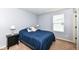 Inviting bedroom featuring neutral walls, bright window, and stylish bedside lamps at 16753 Workington Way, Westfield, IN 46074